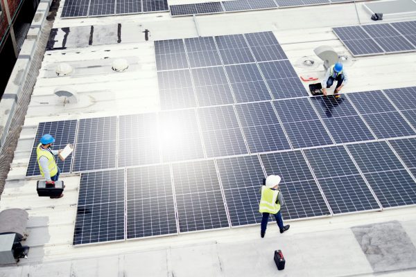 Solar energy, construction and employees building solar panels in collaboration for sustainability,